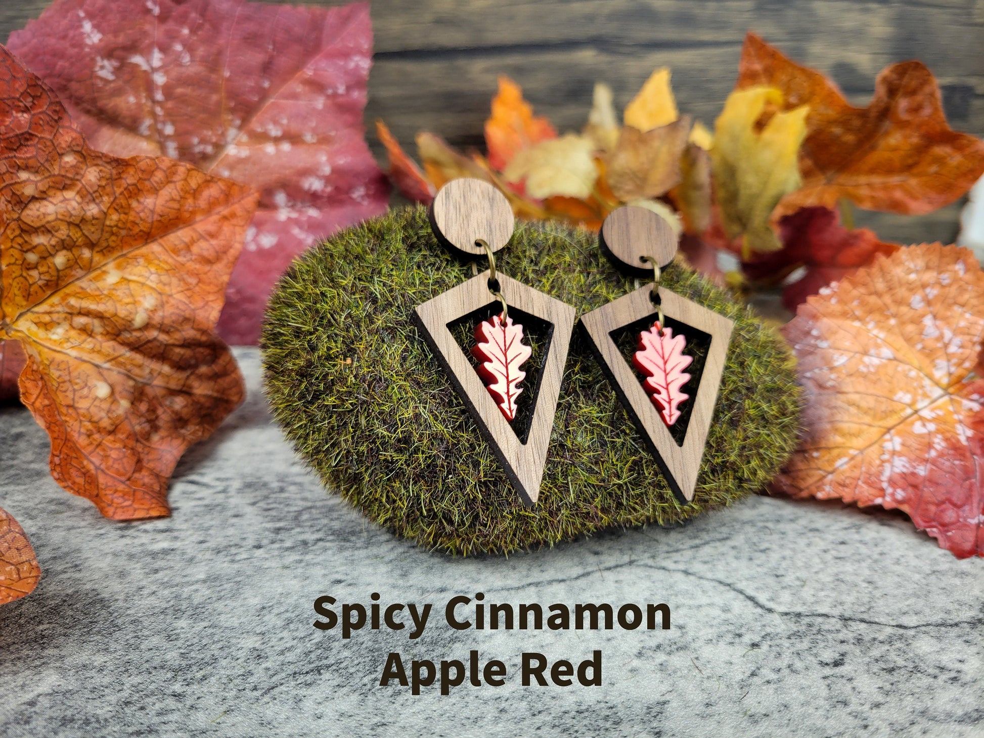 Diamond-shaped walnut wood earrings with metallic acrylic oak leaf dangle in fall colors - apple red angled view