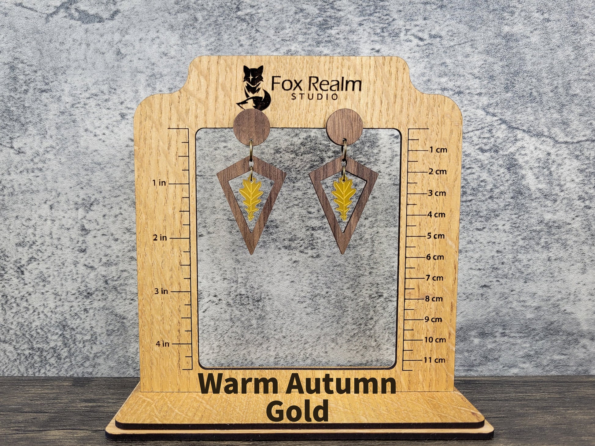 Diamond-shaped walnut wood earrings with metallic acrylic oak leaf dangle in fall colors - size display view