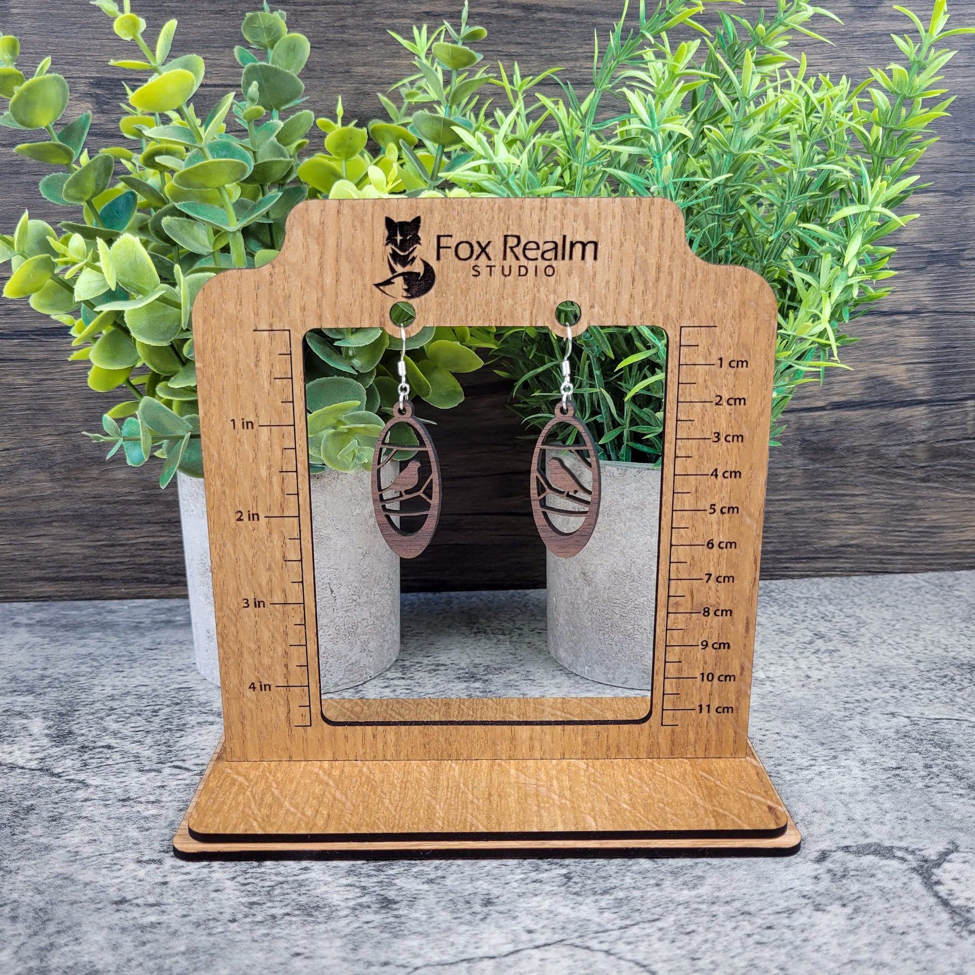 Lightweight walnut wood earrings featuring a bird in branches design on hypoallergenic sterling silver-plated ear wires - size display view