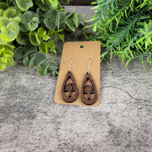 Lightweight walnut wood earrings with bird silhouette design on sterling silver-plated ear wires – top down view