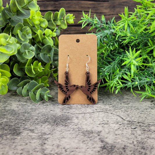 Lightweight walnut wood bird earrings featuring birds in flight design with sterling silver-plated ear wires - front view