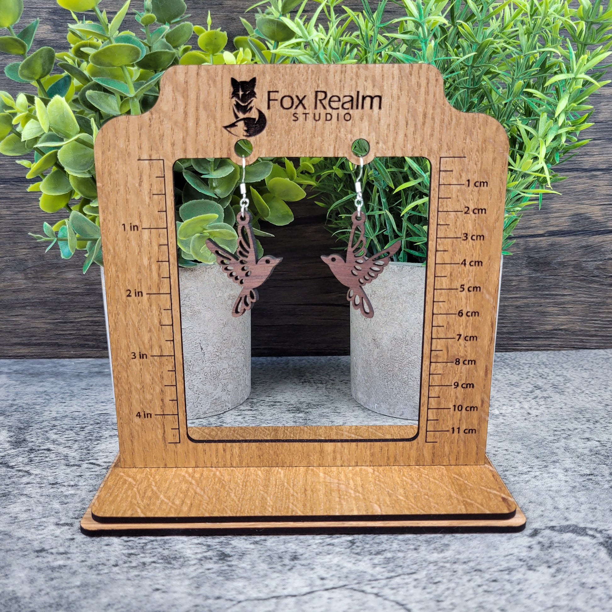 Lightweight walnut wood bird earrings featuring birds in flight design with sterling silver-plated ear wires - size display view