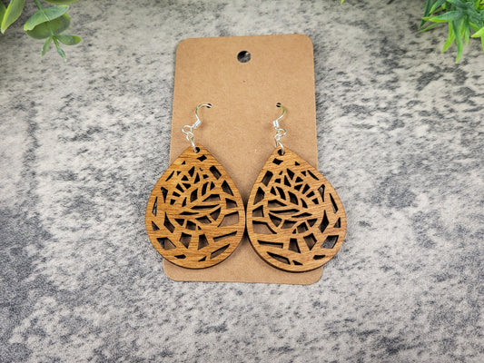 Lightweight botanical teardrop earrings made of laser-cut birch wood with sterling silver-plated hooks – top down view