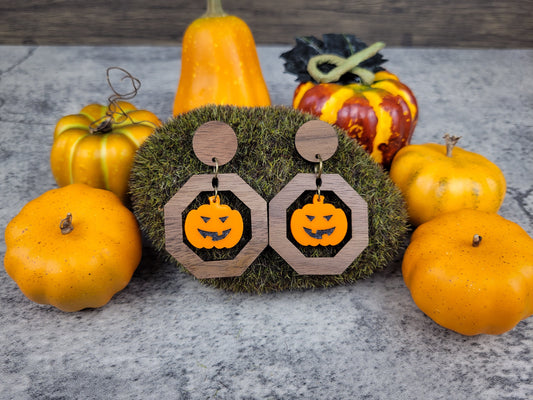 Jack-O-Lantern geometric dangle earrings with walnut studs and acrylic pumpkin from above