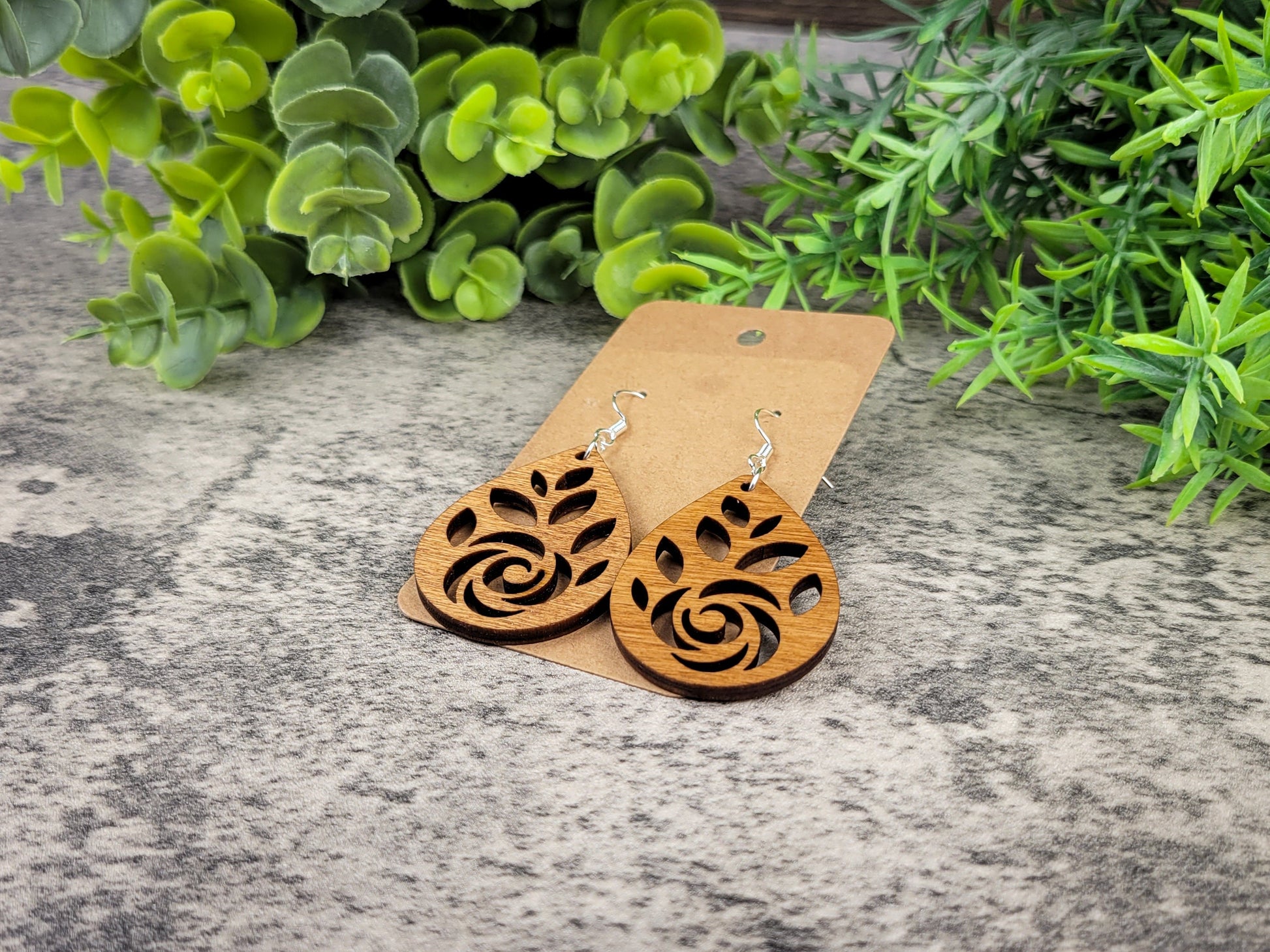 Laser-cut rose teardrop dangle earrings made of birch wood on silver-plated hooks – flat angle view