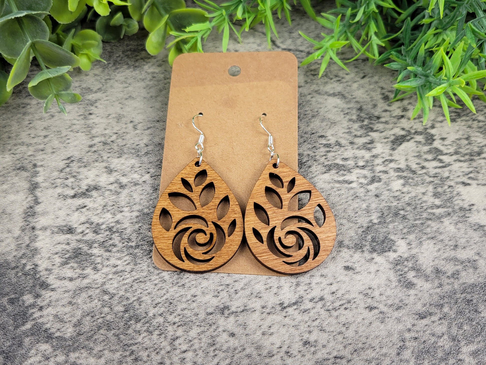 Laser-cut rose teardrop dangle earrings made of birch wood on silver-plated hooks – view from above