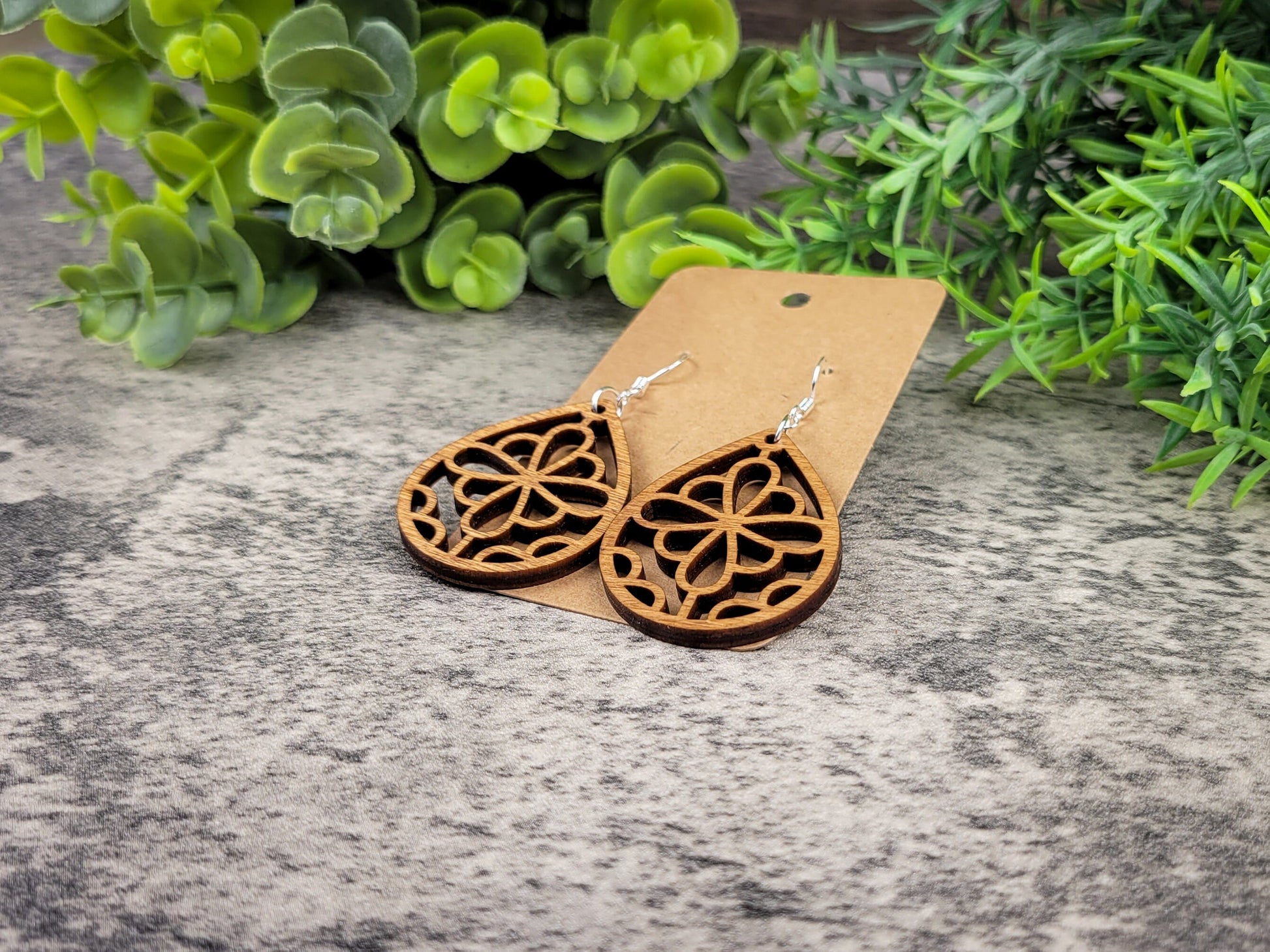 Laser-cut wooden summer flower teardrop earrings with silver ear wires – right angle view