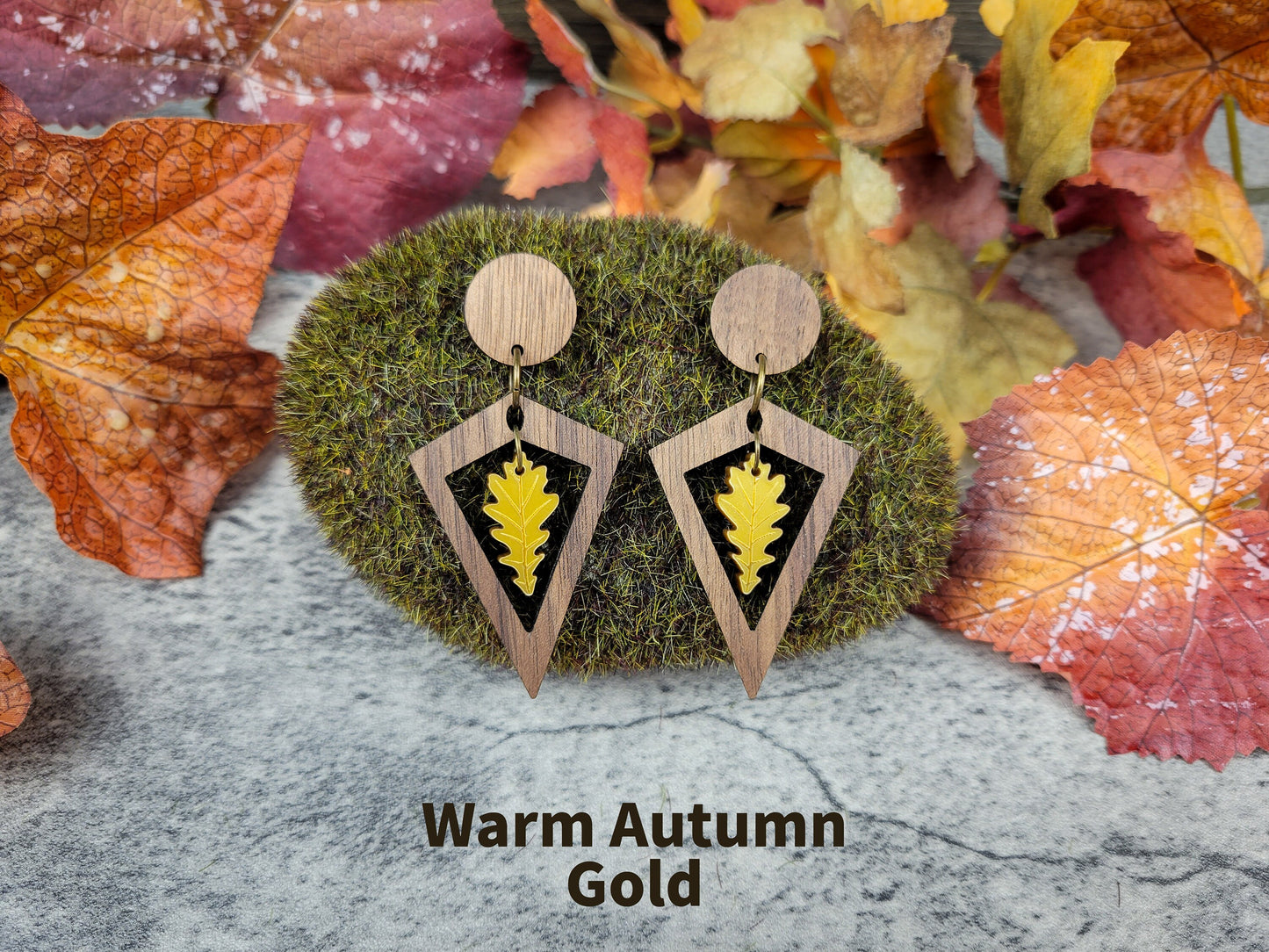 Diamond-shaped walnut wood earrings with metallic acrylic oak leaf dangle in fall colors - autumn gold front view