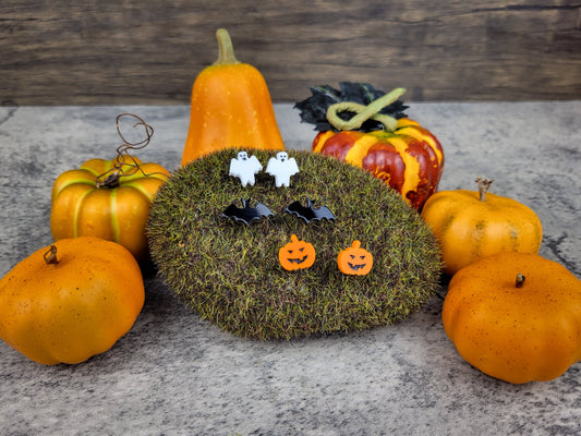 Halloween jewelry collection with ghost, bat, and pumpkin earrings angled view